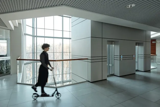 [freepicdownloader.com] blurry outline young active businesswoman riding scooter while moving along corridor inside large office center break normal 11zon